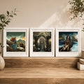 Three framed art prints with white frames are displayed side-by-side on a wooden shelf against a beige wall, decorated with green leaves and small ceramic vases.